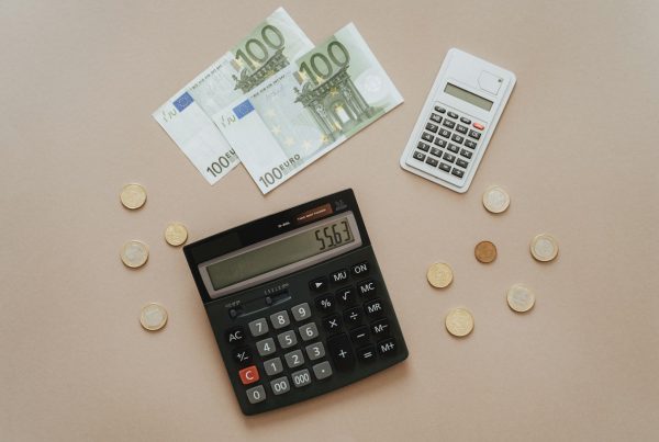 Two hundred euro bills and some change with two calculators